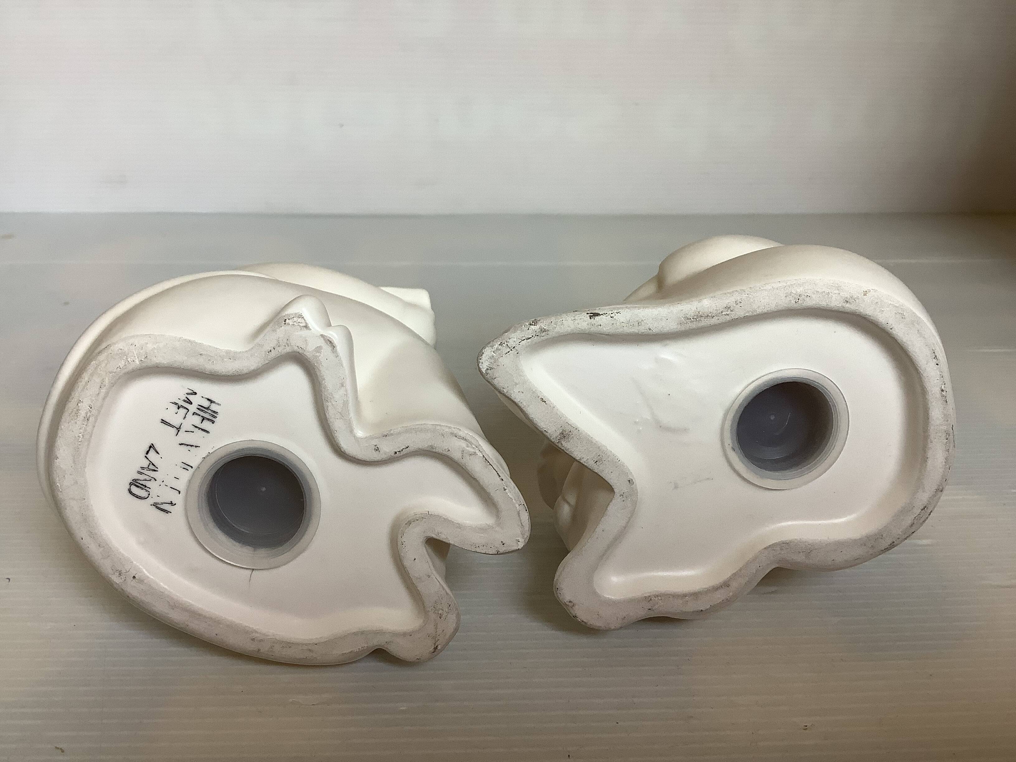 Pair of bookends with a matte white glaze for children.