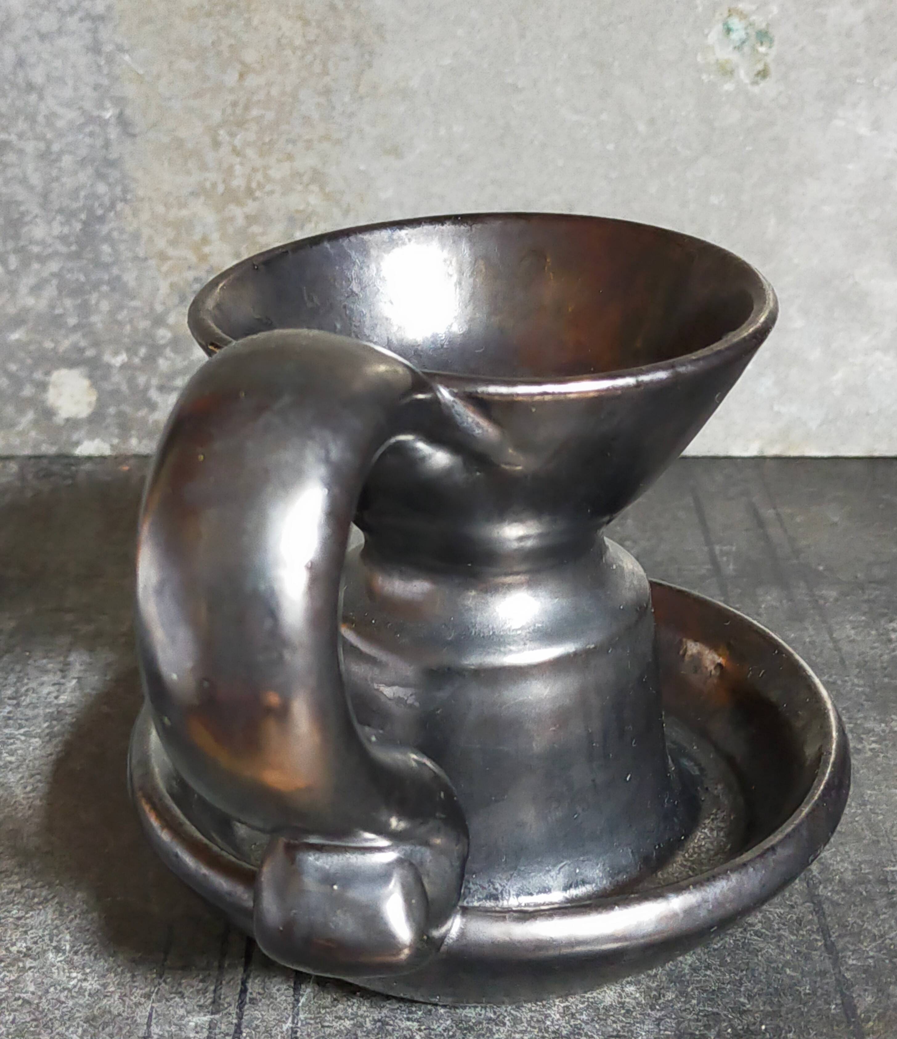 1950s iridescent black ceramic hand candle holder