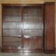 Corner library made of flamed hardwood, in 3 parts.