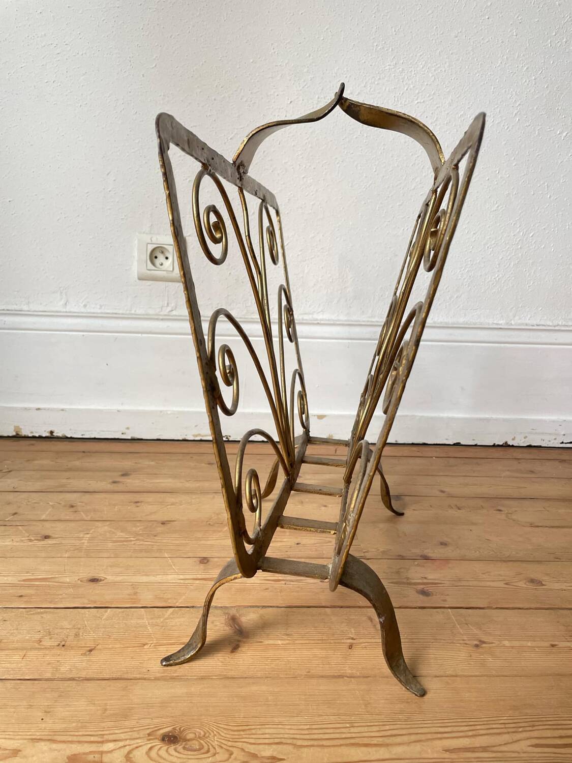 Vintage wrought iron magazine rack with gold butterfly design