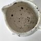 Small speckled ceramic jug in a vintage workshop style.