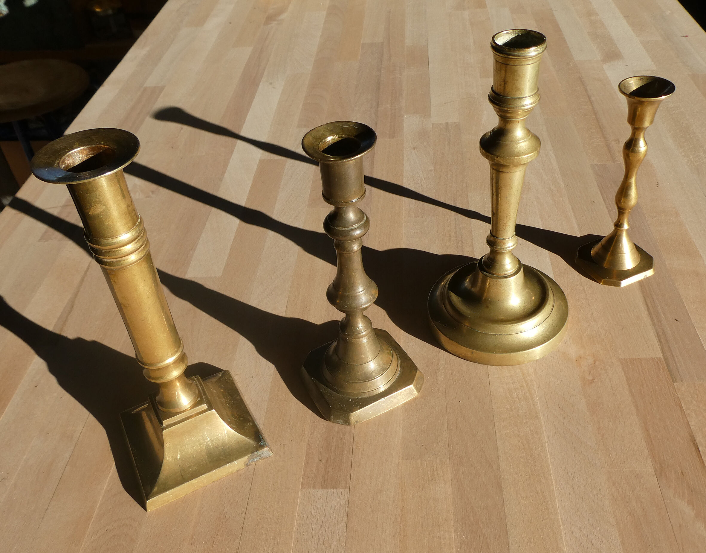 Set of 4 old candle holders in golden brass