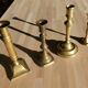 Set of 4 old candle holders in golden brass