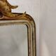 Antique mirror with a gilded frame and cherubs.