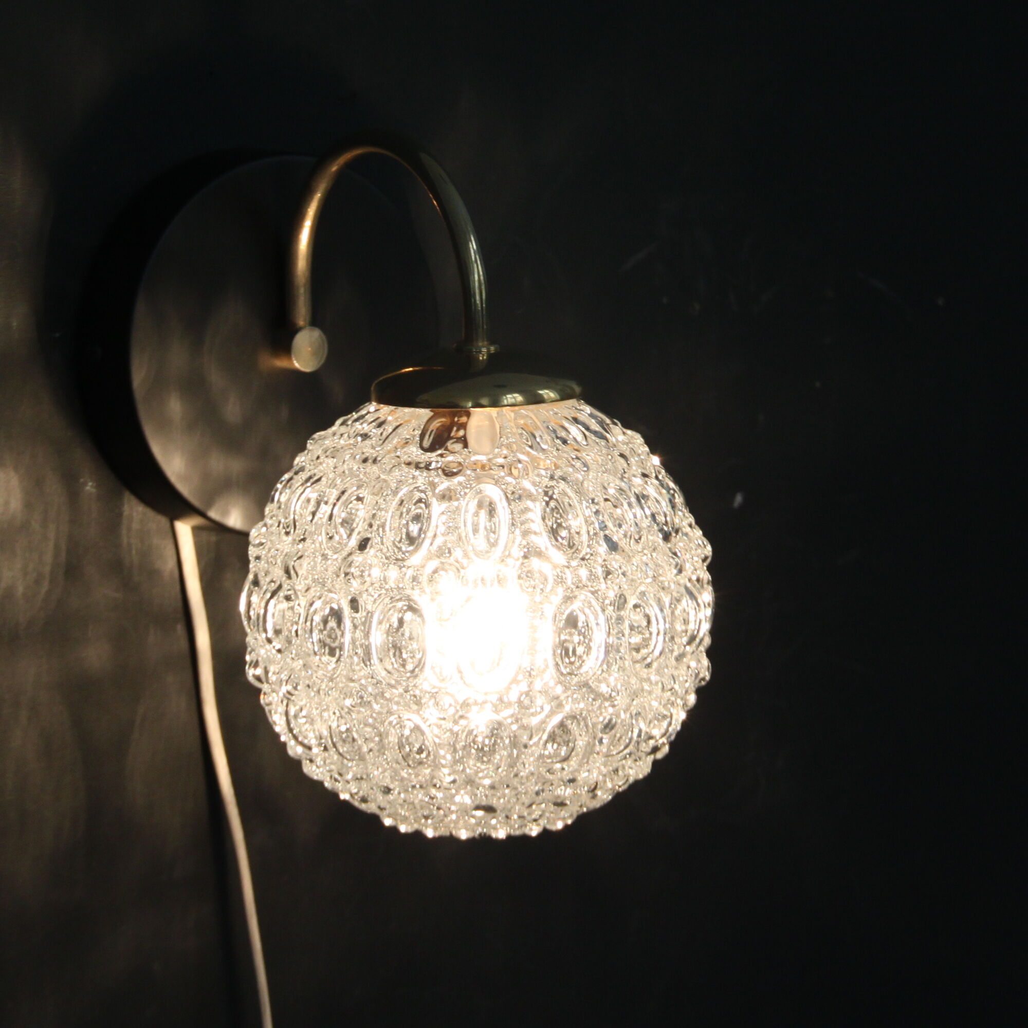 Globe wall light in moulded glass, brass swan collar, circa 1950
