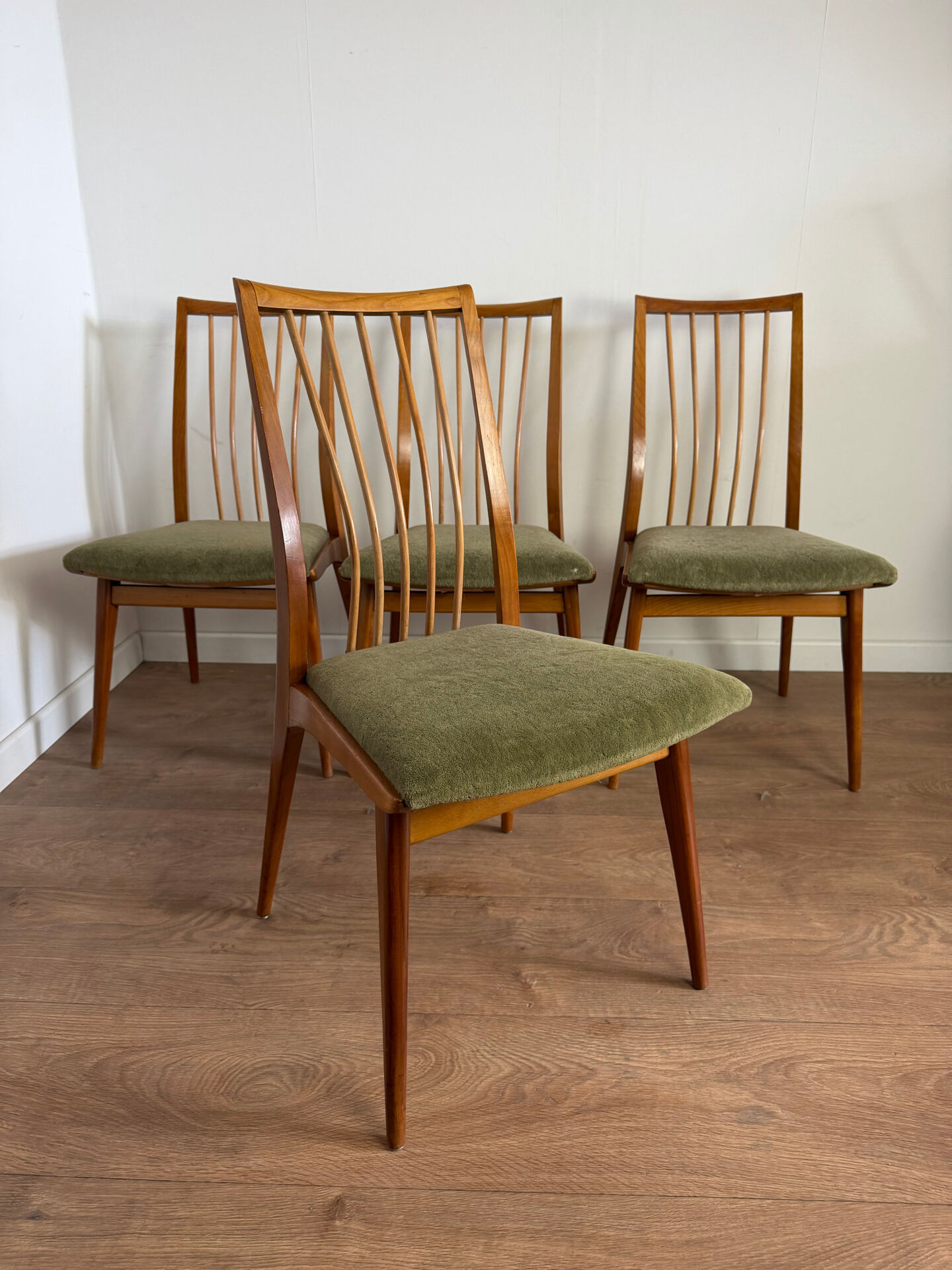Scandinavian chairs with green velvet upholstery.