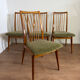 Scandinavian chairs with green velvet upholstery.