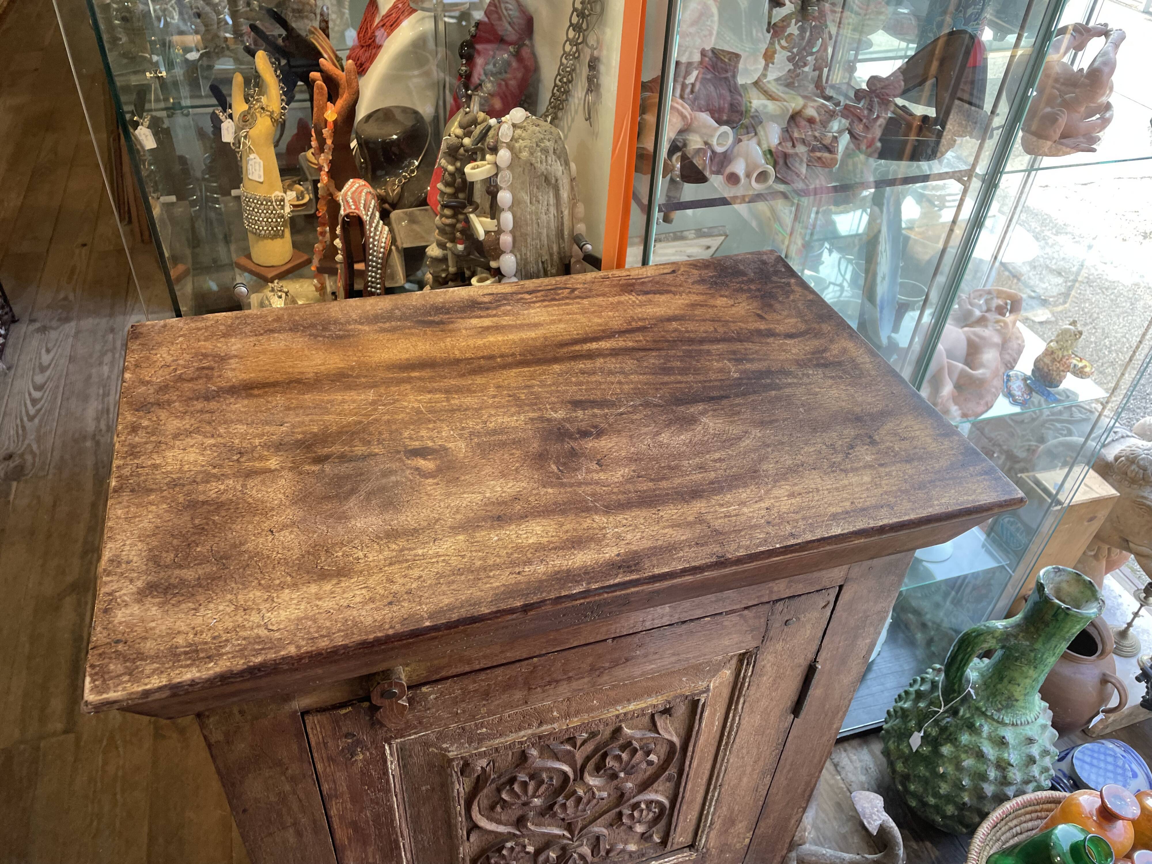 India. Bonnetière with a teak door finely carved by hand.