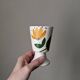 Ceramic mazagran with hand-painted floral decoration.