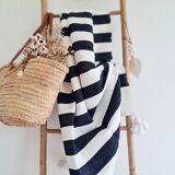 Hand-woven plaid with black stripes and white pompoms