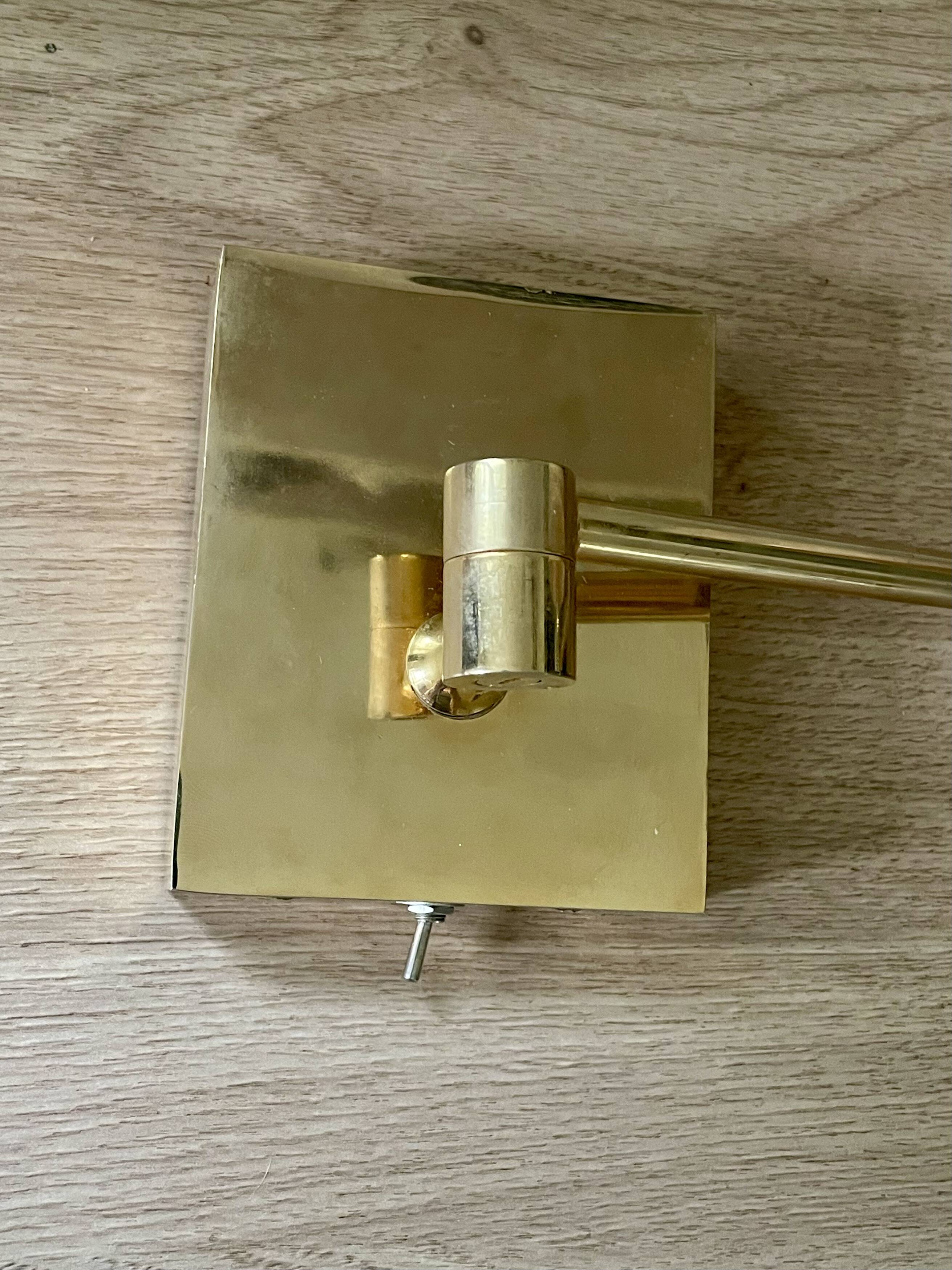 Pair of vintage brass wall lights with adjustable arms.