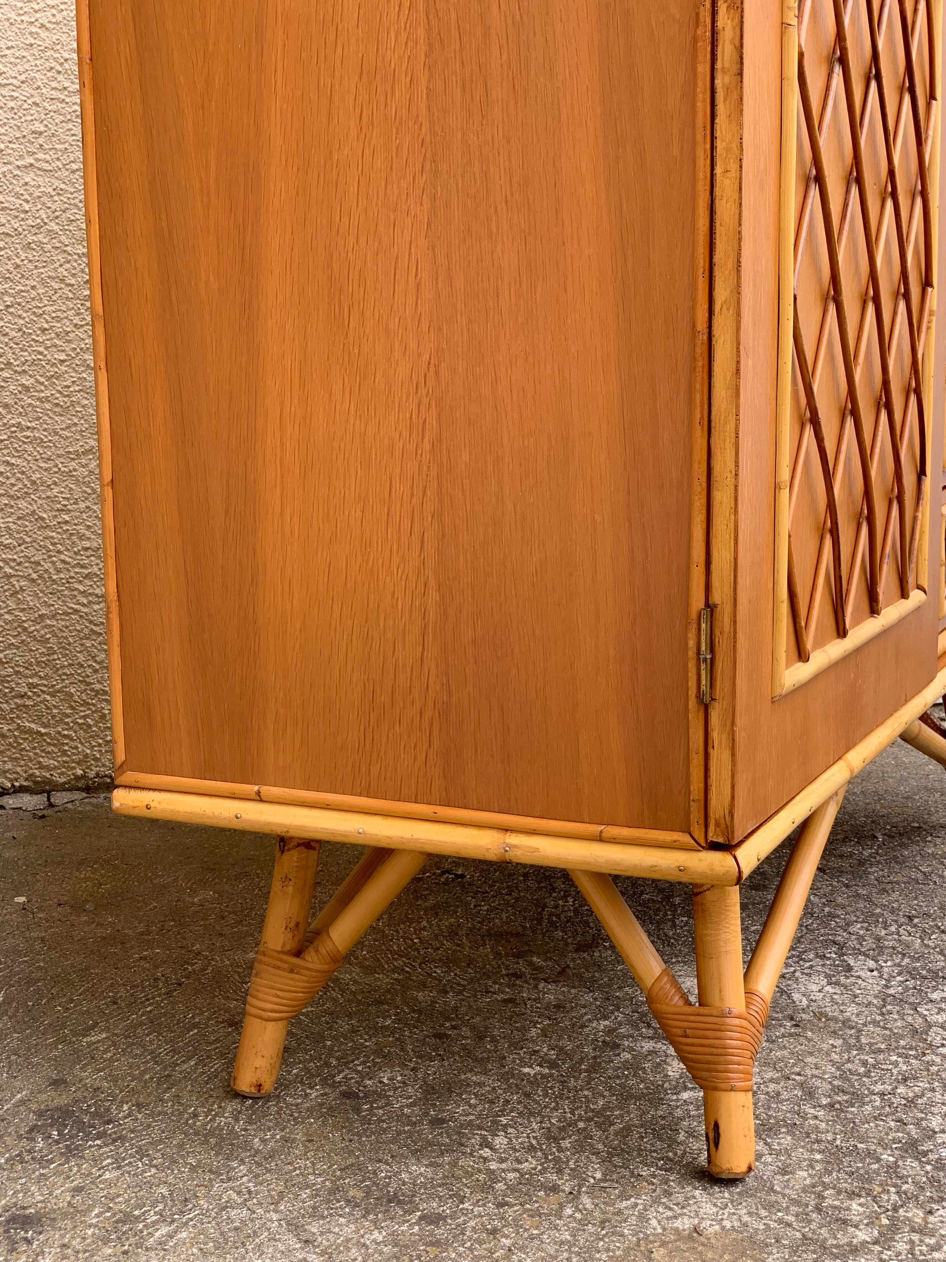 Rattan wardrobe with tapered legs from the 1960s.
