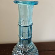 Small vintage turquoise blue glass carafe with floral design.