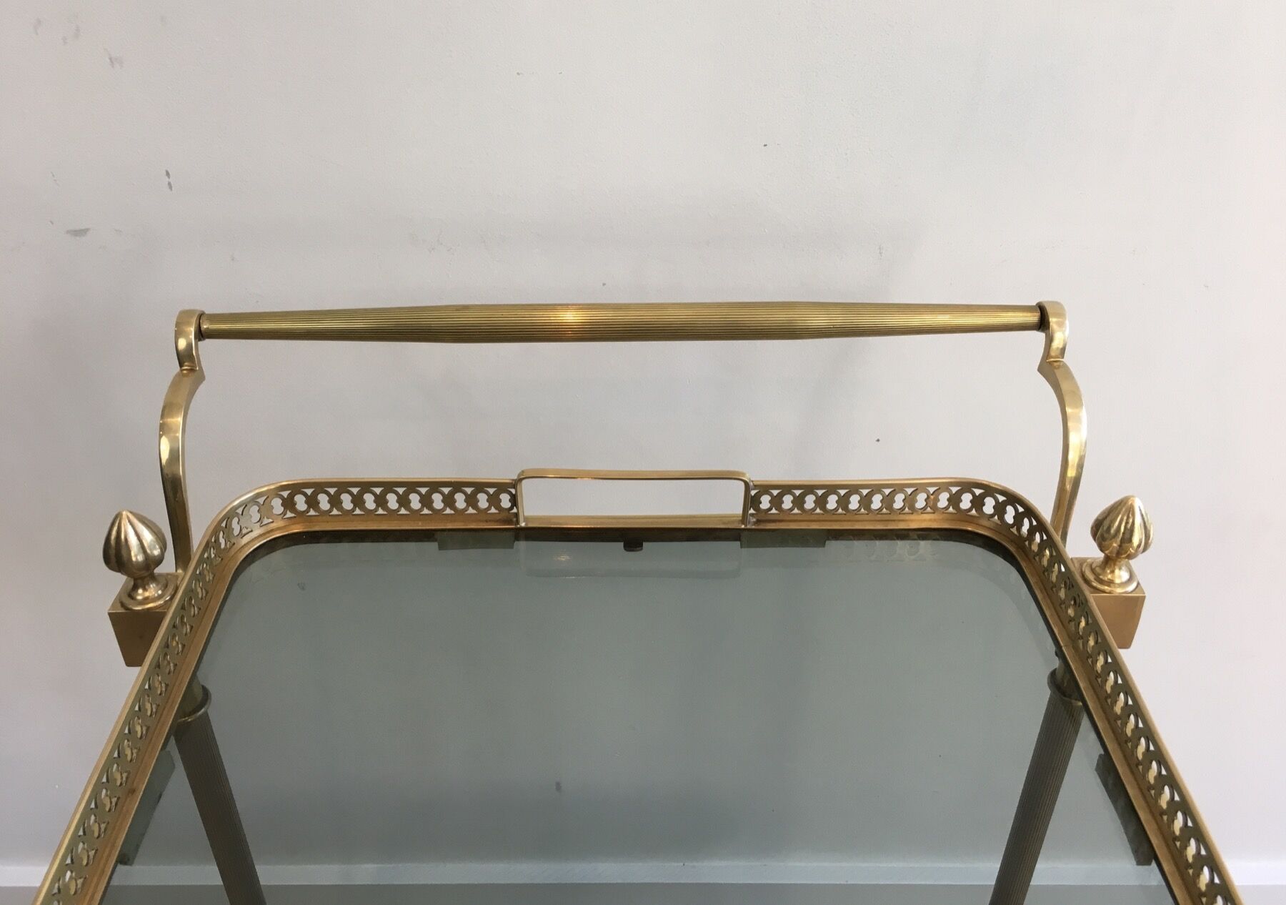 Neoclassical style rolling table in brass with blue glass tops