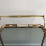 Neoclassical style rolling table in brass with blue glass tops
