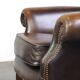 Chesterfield wing chair in dark brown leather with a luxurious appearance