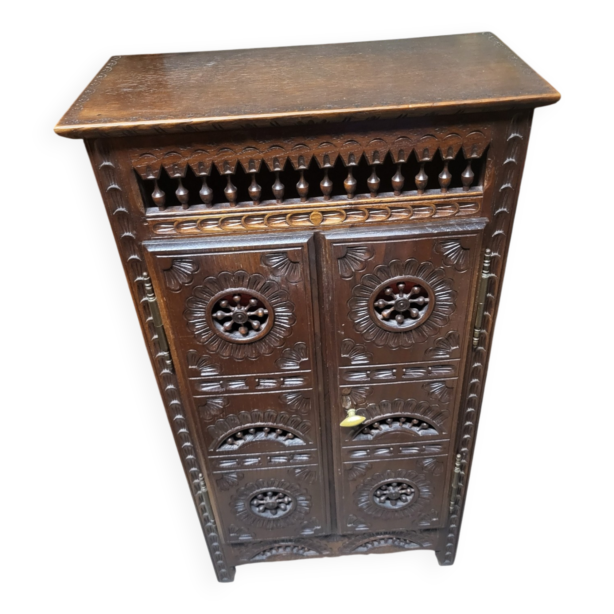 Small antique side table in carved wood.