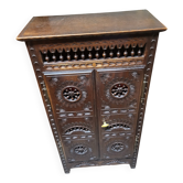 Small antique accent piece in carved wood.