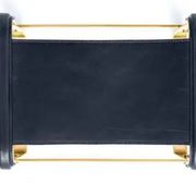 Contemporary kitchen bar stool in aged brass metal and navy blue leather.
