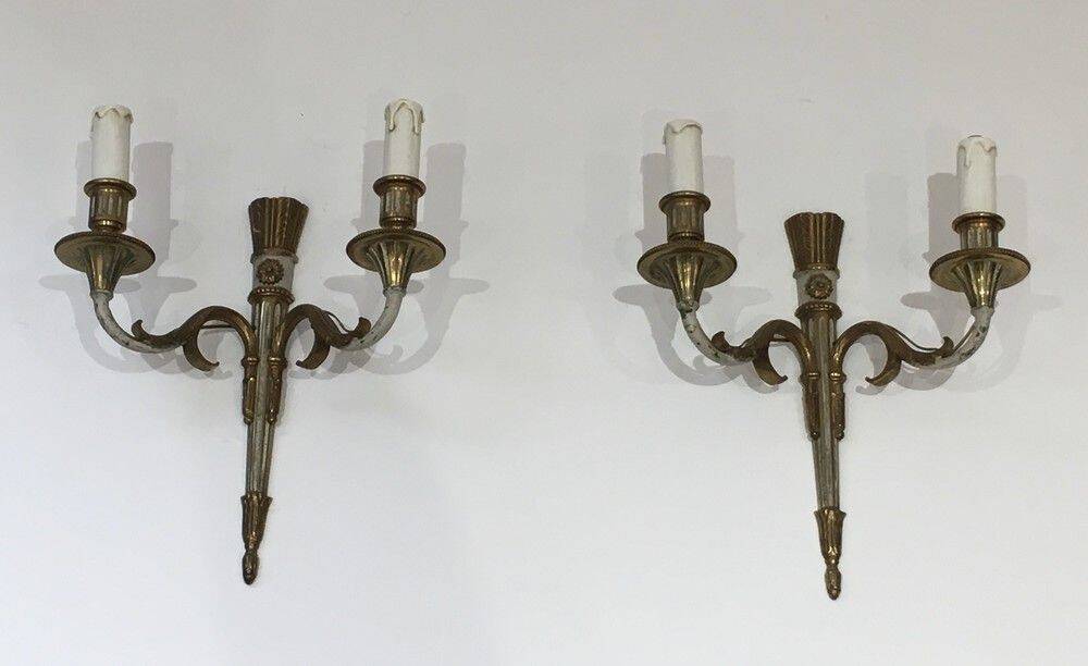 Pair of Louis XVI style wall sconces in bronze with an off-white patina