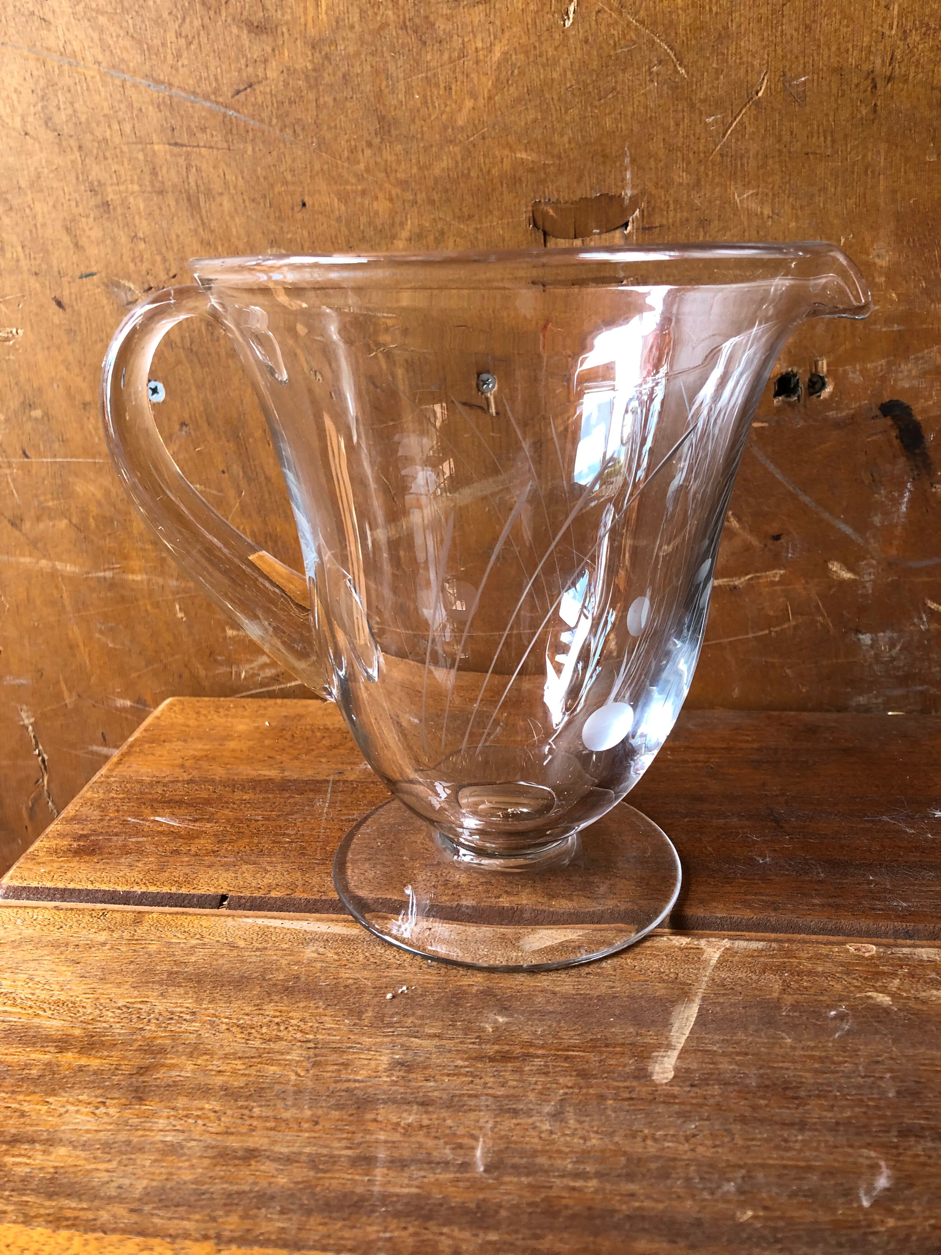 Old pitcher service and 5 foot glasses in engraved glass vintage table art