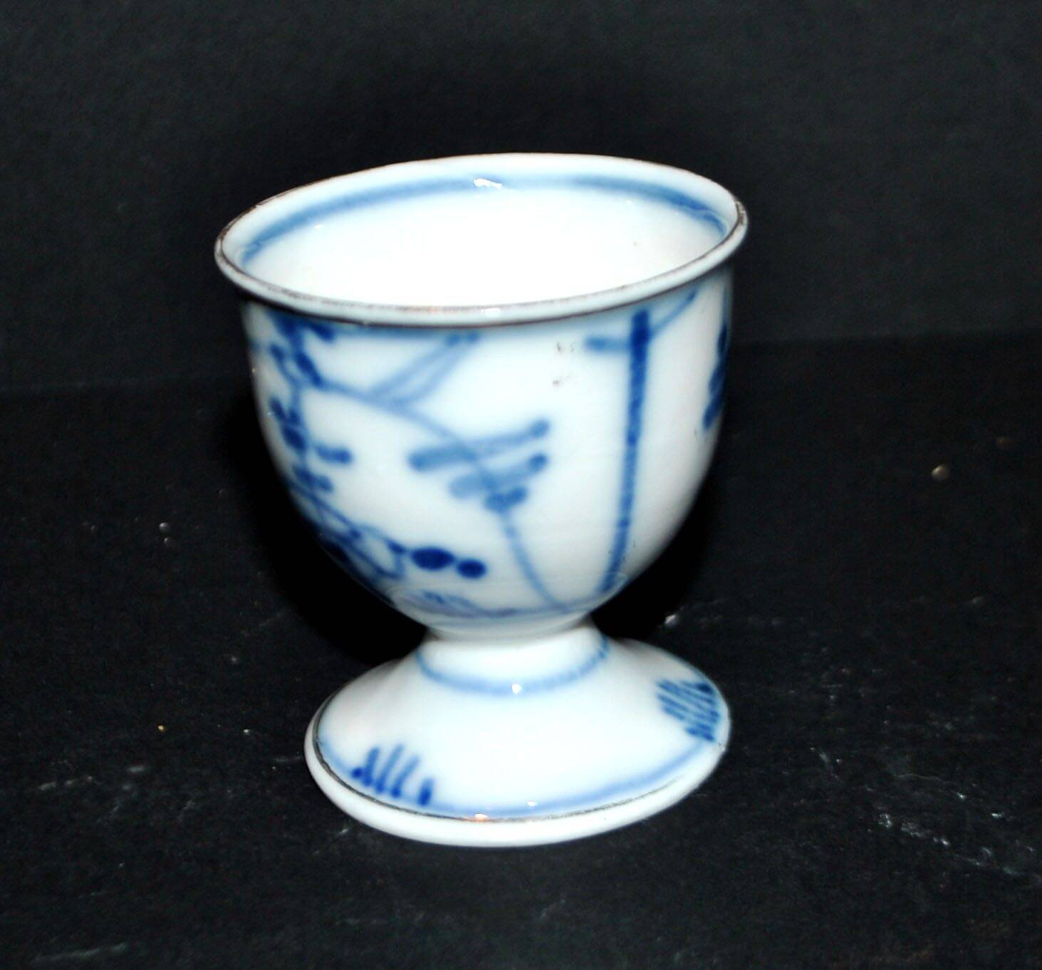Antique porcelain diabolo egg cup with blue hand-painted onion decoration