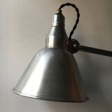 Old industrial lamp has vise 'mazda '.