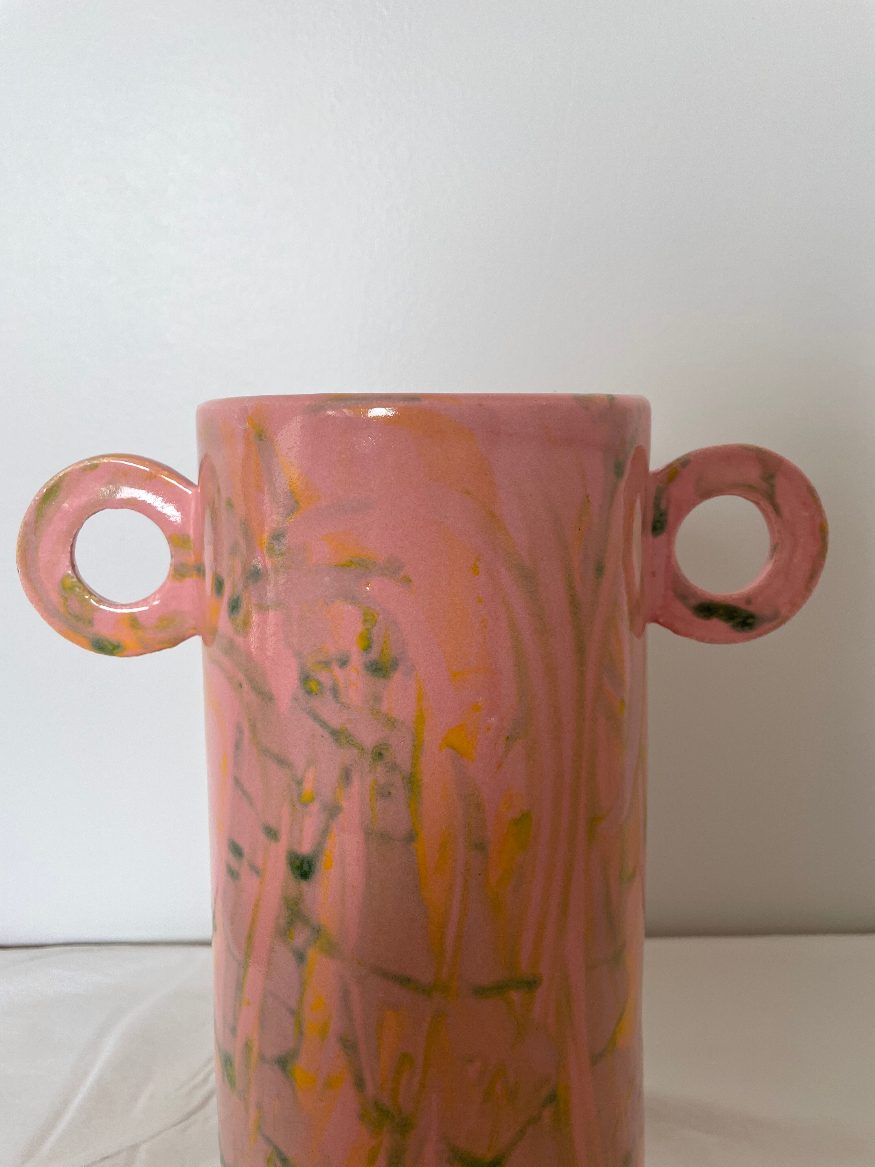 Pink ceramic vase with abstract circular handles