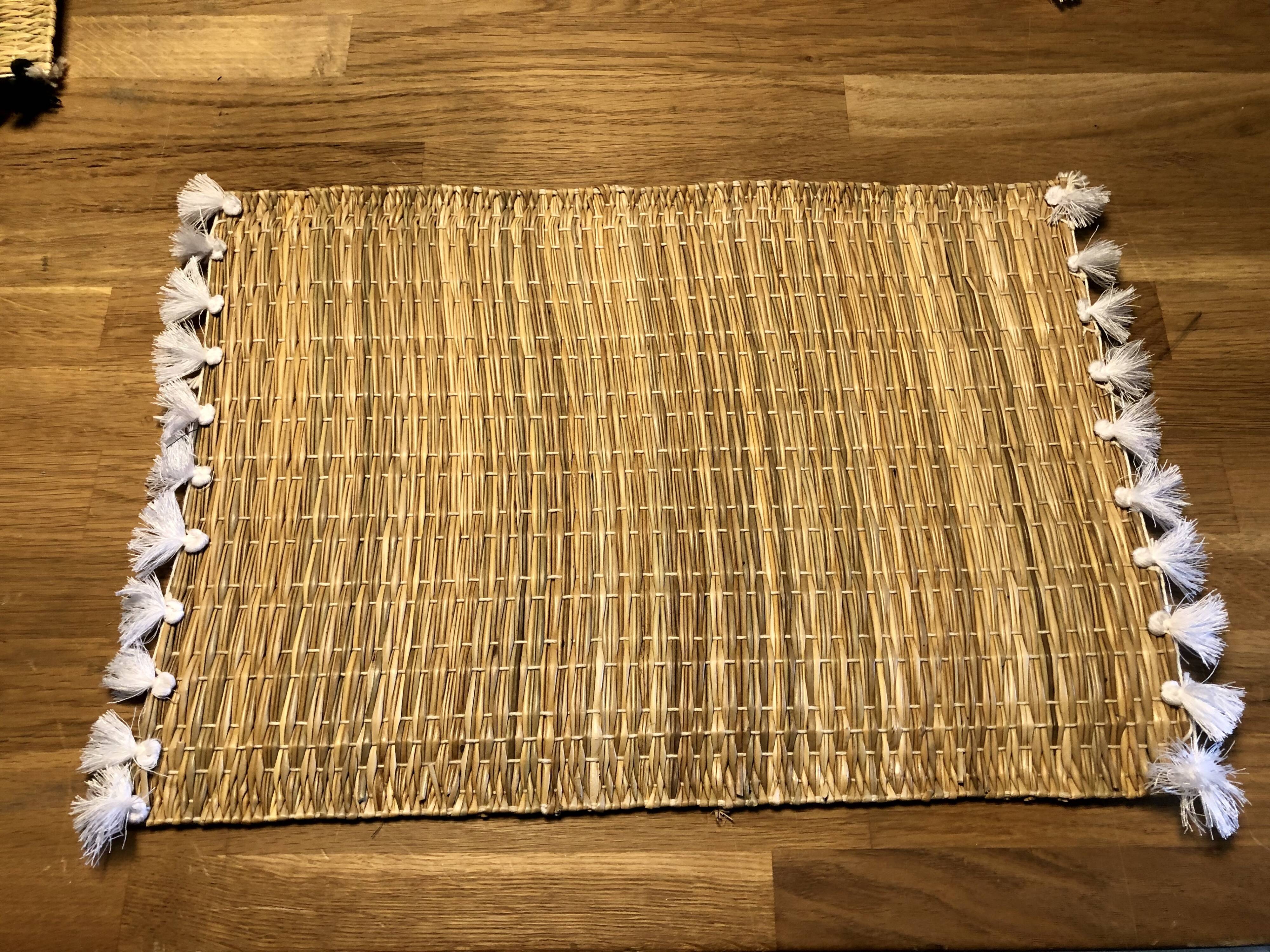 Braided placemats with pompoms