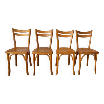 Set of 4 authentic Baumann bistro chairs in light wood.