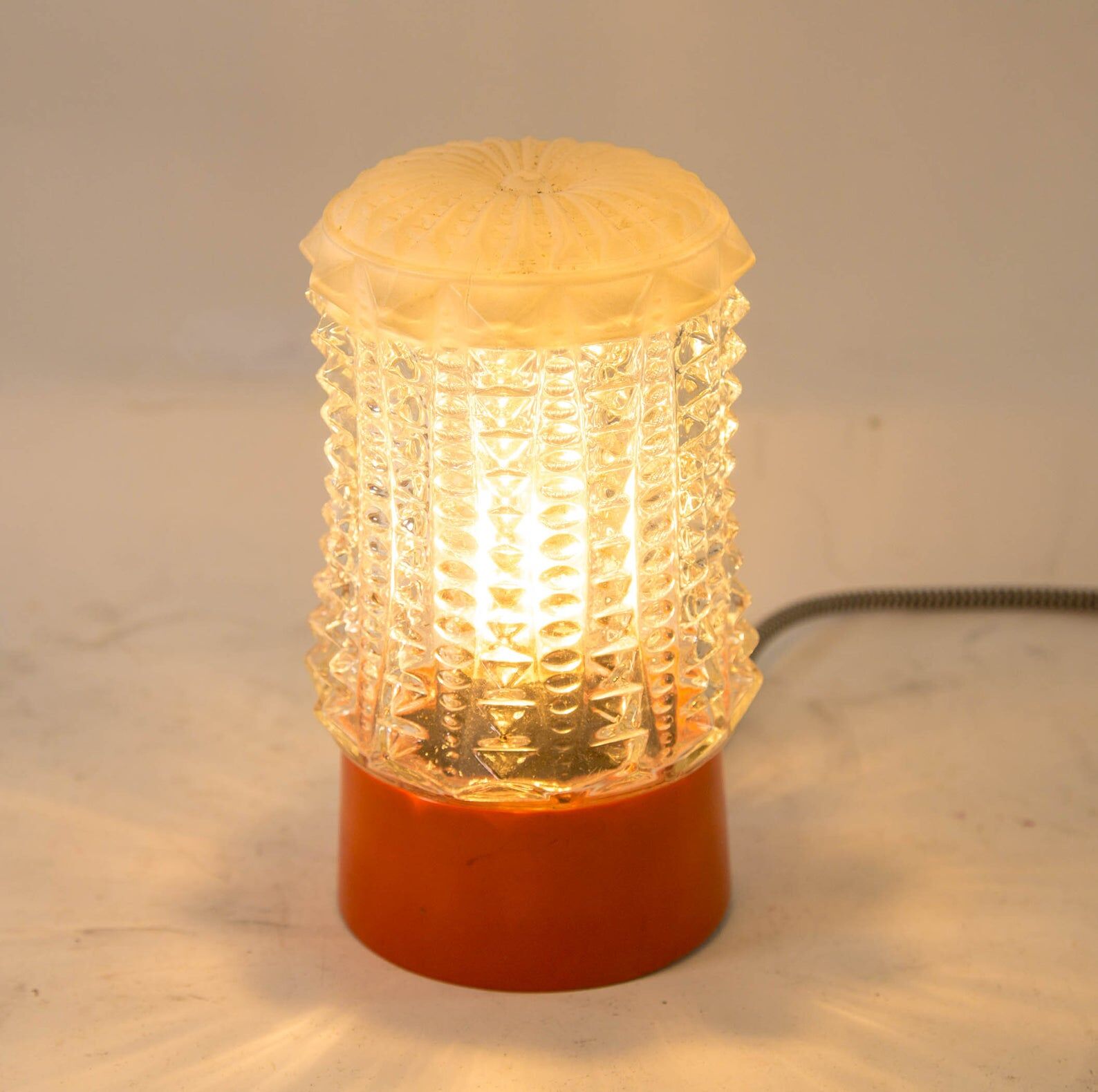 Built-in glass dome and vintage round orange base from the 70s