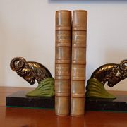 Art Deco pair of bookends with ram's heads, patinated metal and black marble.
