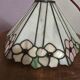 Tiffany-style stained glass lampshade with floral motifs.