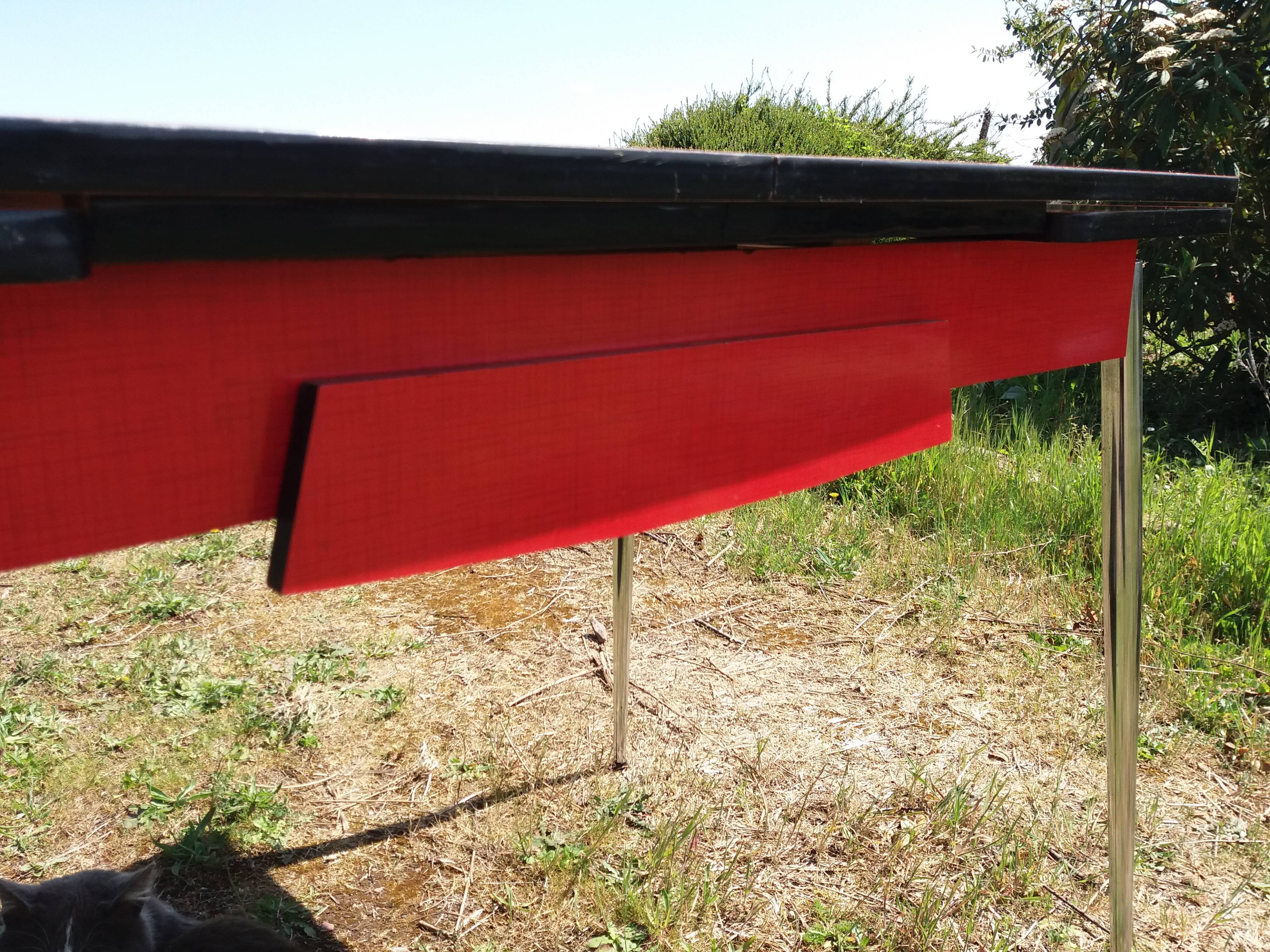 Dining table with red formica extensions