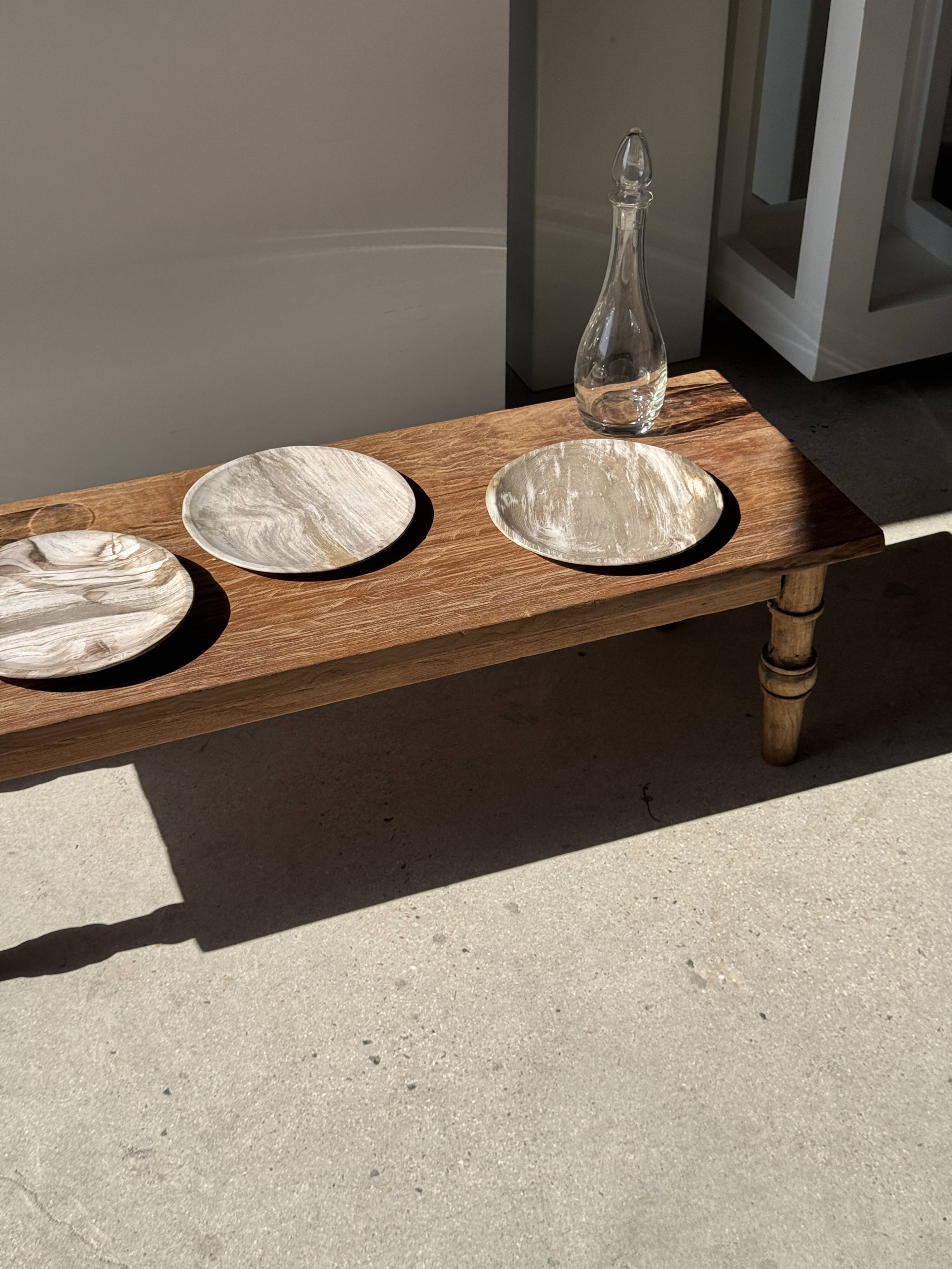 Tray, circular dish or plate made of white striped grey petrified wood.