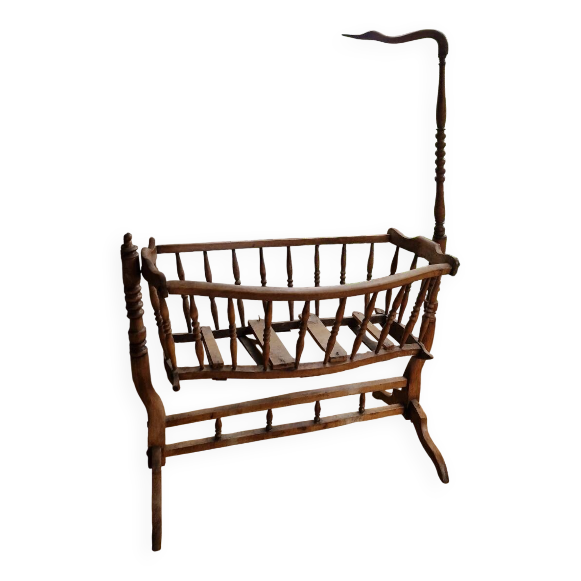 Wooden cradle in walnut with a sign collar at the top.