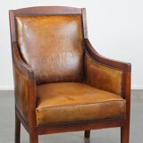 Sheepskin and wooden vintage Art Deco design armchair in a cognac color