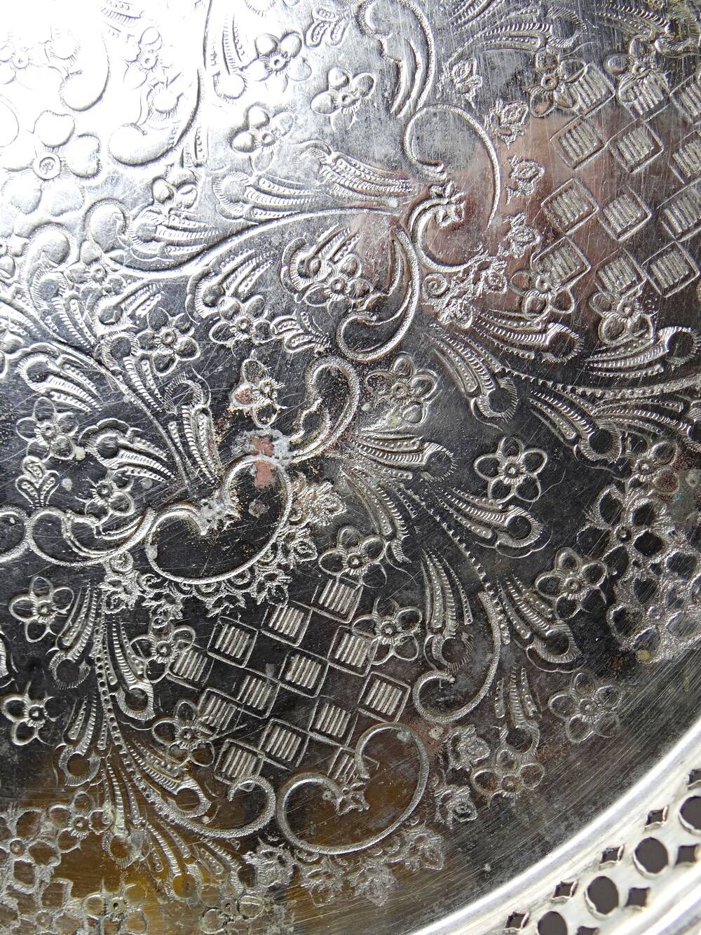 Small Moroccan tripod tea tray in silver-plated metal, vintage chiseled decoration.