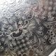 Small Moroccan tripod tea tray in silver-plated metal, vintage chiseled decoration.