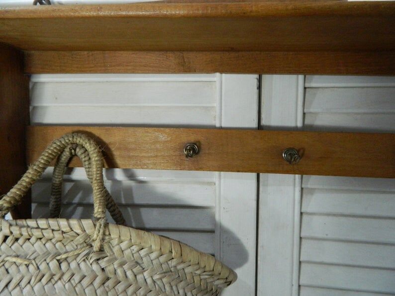 Wooden shelf with hooks and towel holders
