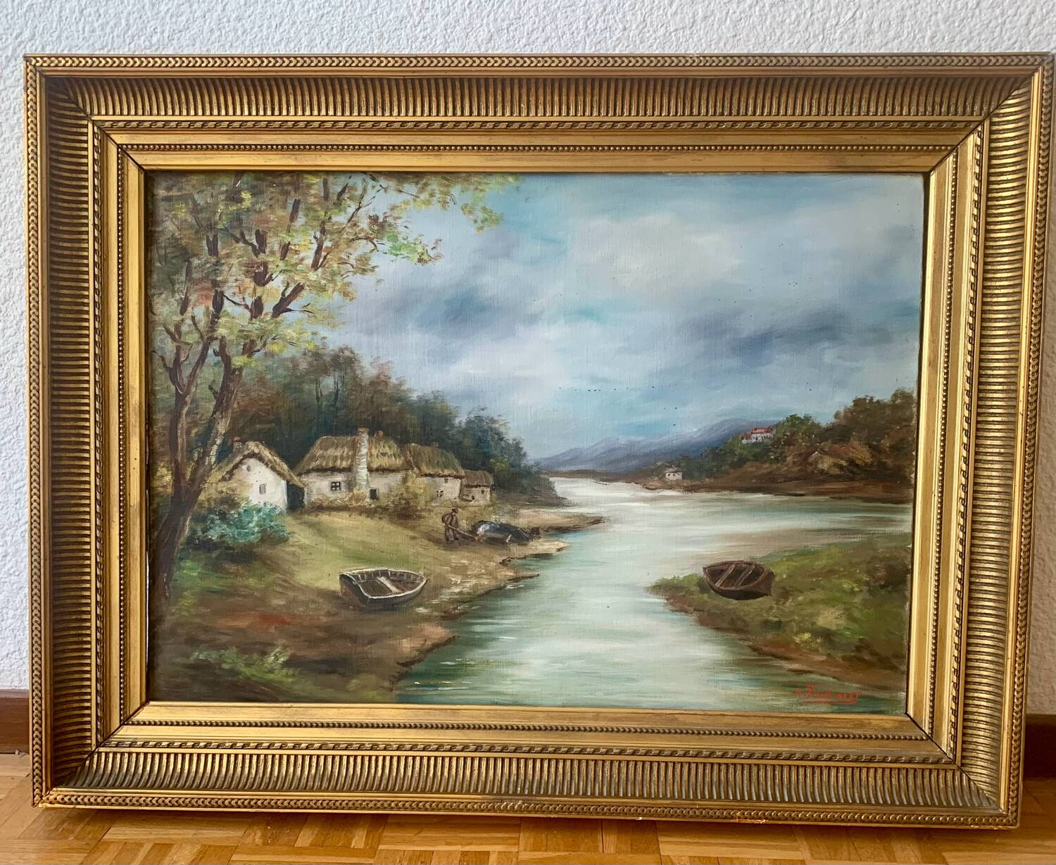 Large painting of a house by the water