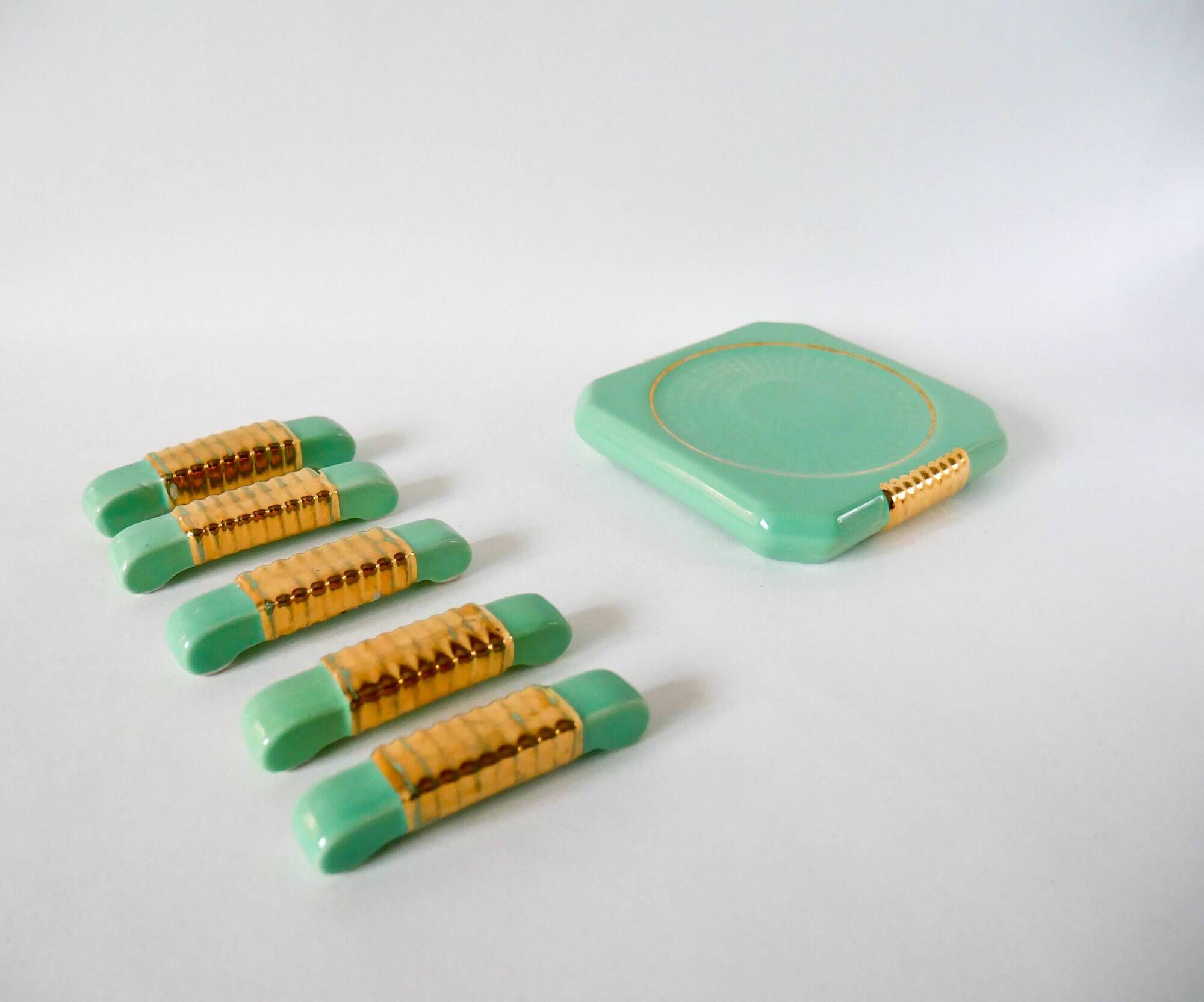 set of coasters and knife holders in mint green and gold art deco ceramic 1930