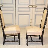 Pair of low armchairs in blackened wood