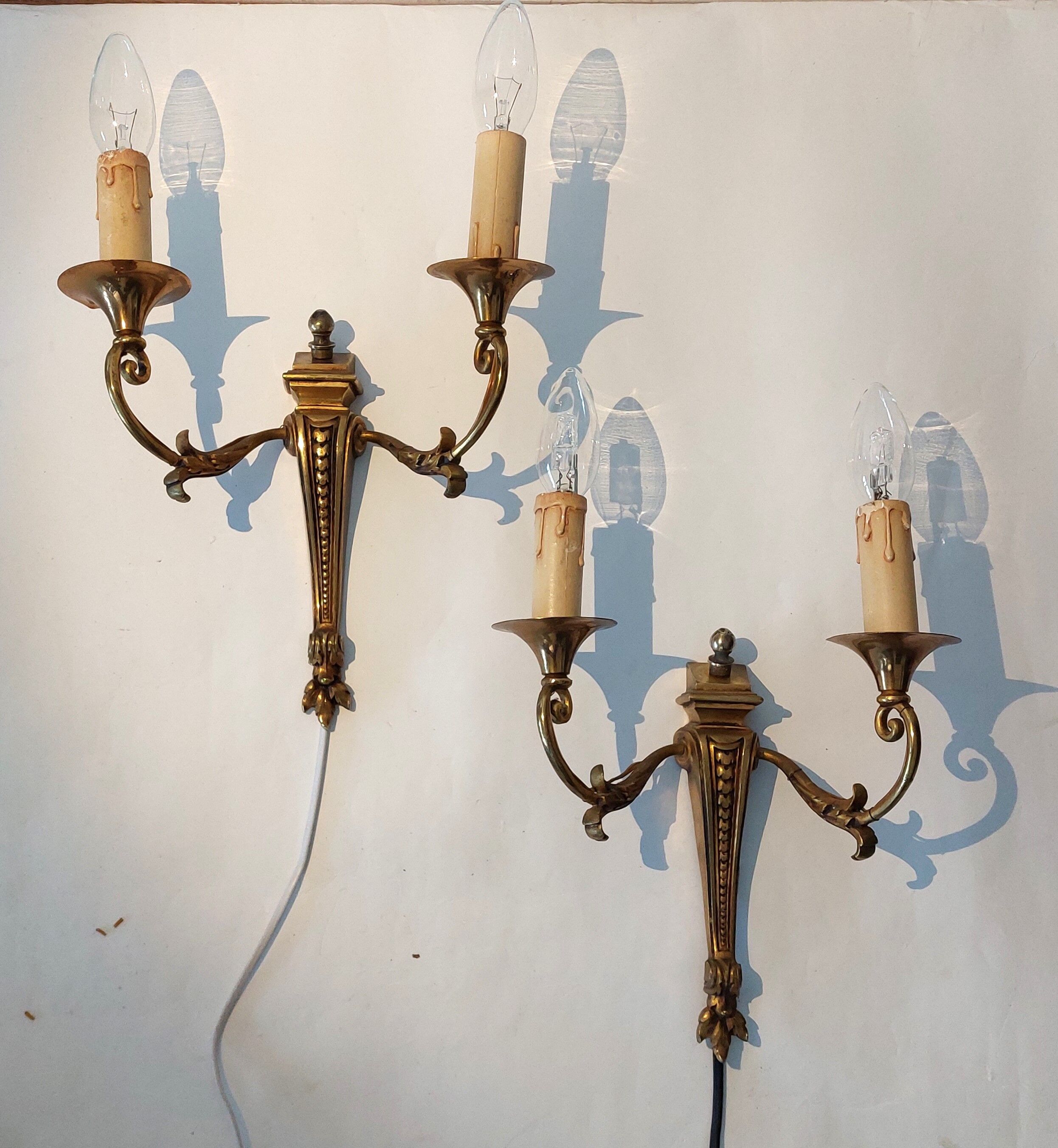 Pair of neoclassical sconces in bronze and gilded brass 1950.
