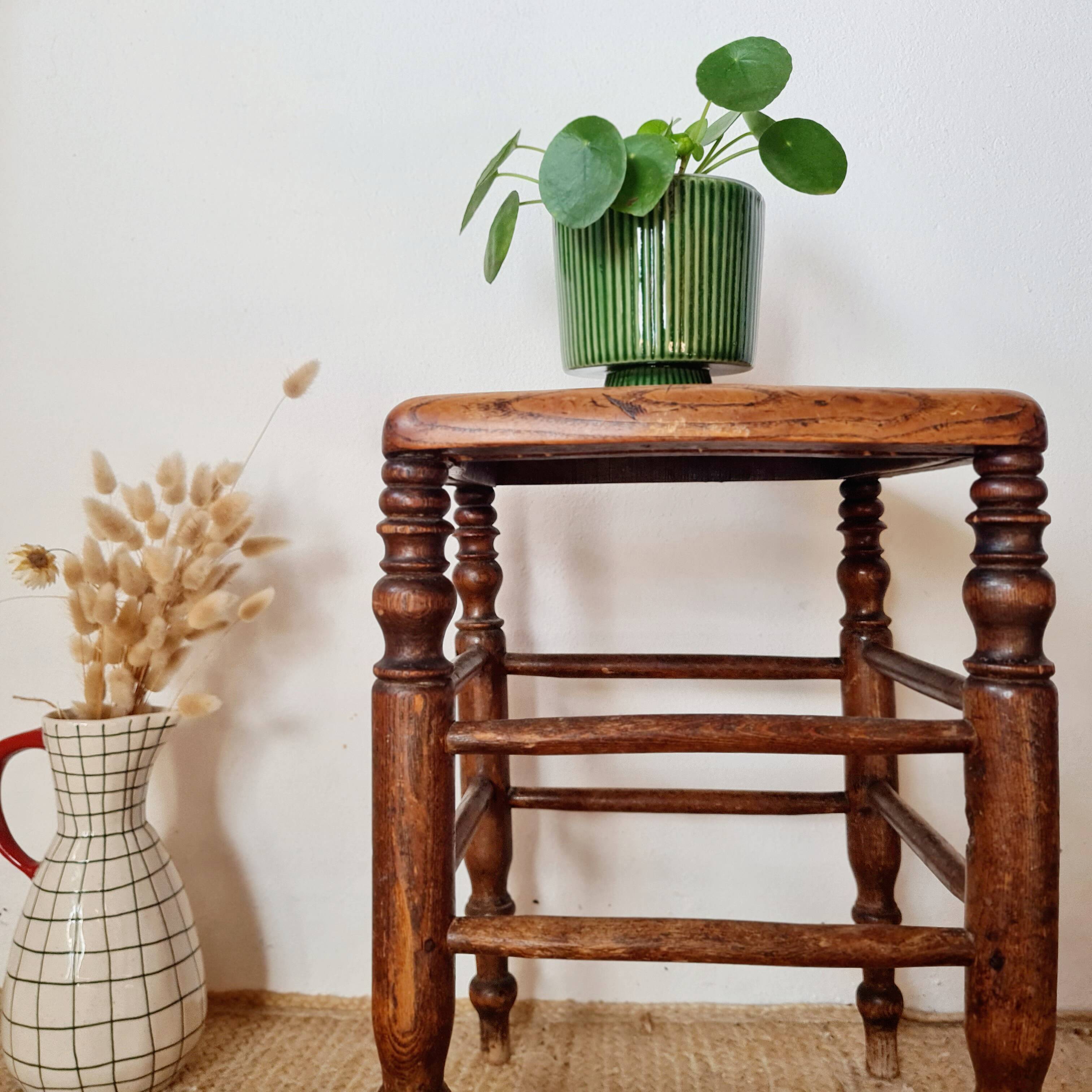 Wooden stool with cane seat
