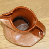 Brown painted earthenware pitcher