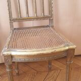 Pair of Louis XVI caned chairs with carved gilded wood.