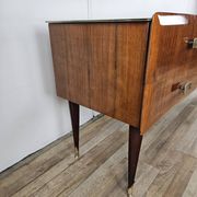 Mid-century drawer chest in mahogany, brass and glass.