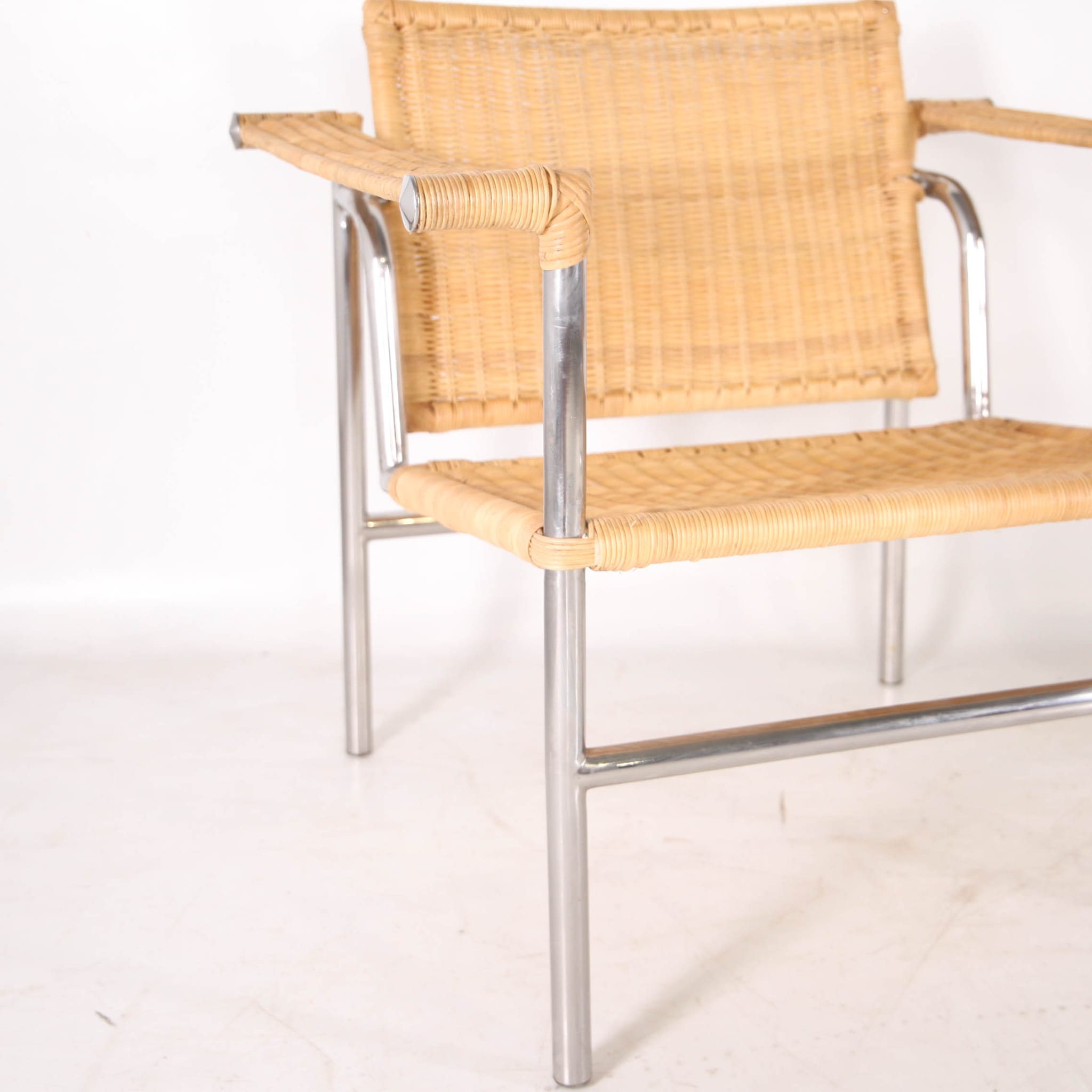 Pair of wicker and chrome armchairs