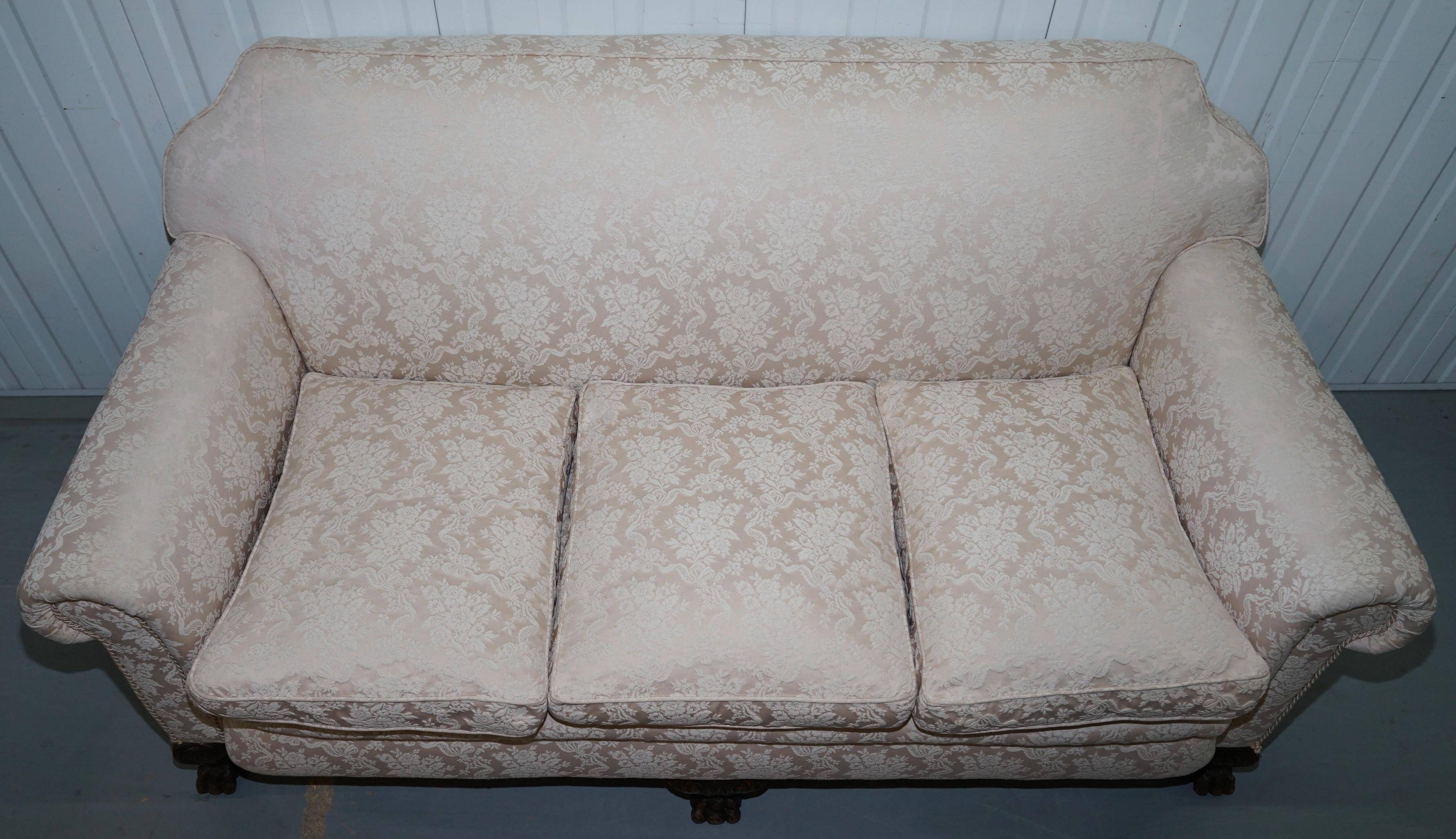 Victorian suite in damask, walnut frame, legs carved in lion's paw.